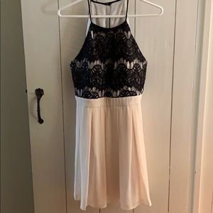 Black and cream halter cocktail dress.